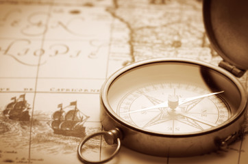Fototapeta na wymiar antique compass on vintage map background
