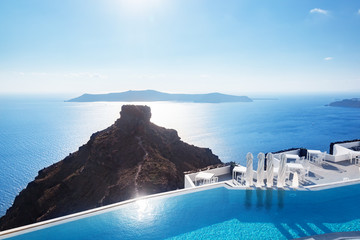 Swimming pool with a view on Caldera over Aegean sea, Santorini, Greece