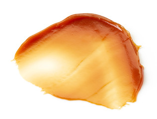 Caramel sauce on white background