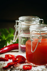 Fototapeta na wymiar Mexican Tabasco hot sauce with red pepper, vinegar and salt, sel