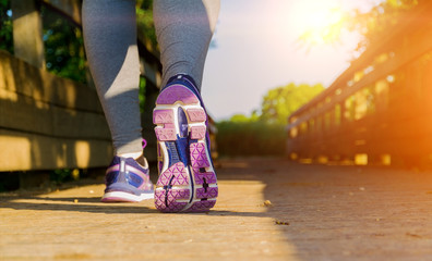 Woman running at sunset in a field