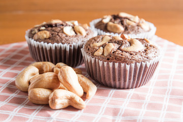 Cup of Brownies With Cashew nuts On Wooden Background