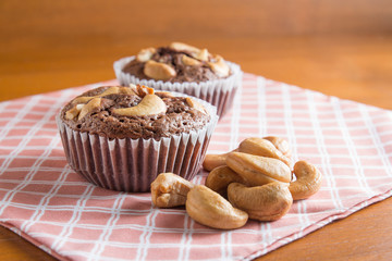 Cup of Brownies With Cashew nuts On Wooden Background