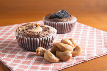 Cup of Brownies With Cashew nuts On Wooden Background