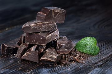 Dark chocolate pieces on a wooden table