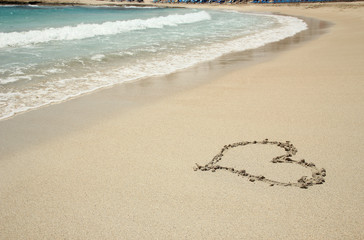 heart trace in the sand seashore