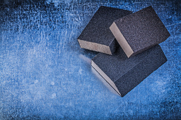 Sanding sponges on metallic background abrasive tools