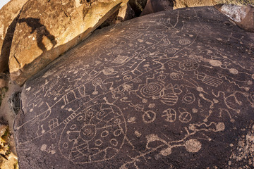 Hiker admires native american rock art.