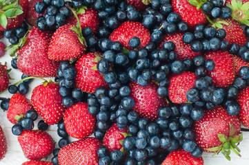 Strawberries and blueberries on a white background