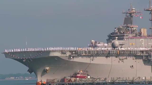 Navy families welcome home servicemen from an aircraft carrier.