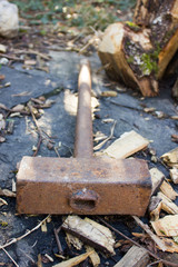metal rusty hammer on a wooden