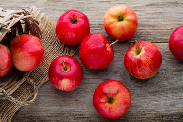 Ripe red apples on wooden background.