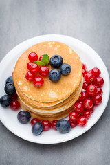 Stack of pancakes with blueberry and fresh berry.