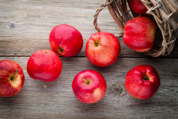 Ripe red apples on wooden background.