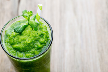 Rucola smoothie, on the grey  background.