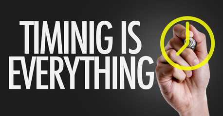 Hand writing the text: Timing is Everything