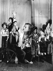 Young woman playing with puppets on the string 