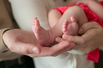 Cute feet of a newborn girl