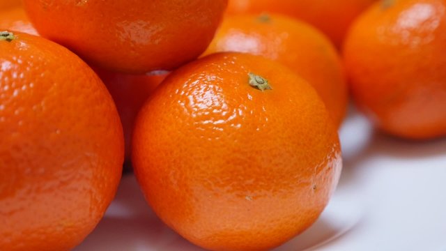 Tangerines on plate healthy fruit orange background 1080p FullHD video - Slow tilt on food and fruit mandarine on table 1920X1080 HD footage 