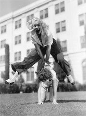 Two women playing leap frog together  - 104428666