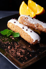 exquisite cream dessert eclair with fresh mint leaves