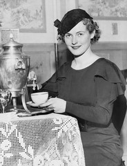 Woman pouring coffee from a coffee urn 