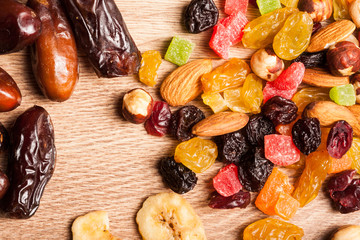 Dried fruits and nuts on wooden background
