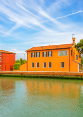 Colorful apartment building with nice waterfront view in Burano, Venice, Italy.