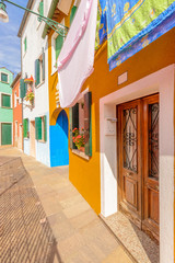 Fototapeta na wymiar Entrance of a colorful apartment building in Burano, Venice, Italy.