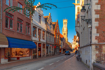Plakat Scenic cityscape with a medieval street and tower Belfort in the christmas morning in Bruges, Belgium