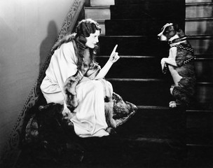 Obraz premium Woman scolding dog on stairs 