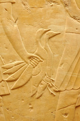 Ancient Egyptian engraving in stone of two ducks being brought to a banquet