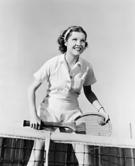 Fotobehang Portrait of female tennis player at the net  © everettovrk