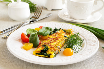 Omelet with spinach and lettuce tomato.