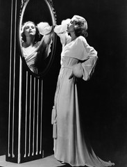 Fototapeta premium Glamorous woman looking in mirror 