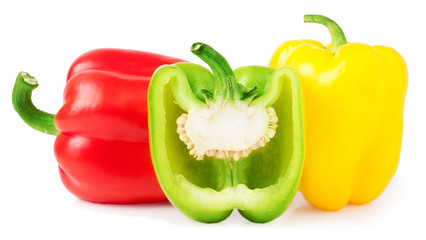 Red yellow and half green bell peppers on a white 