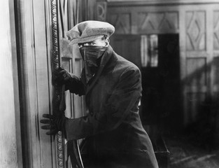 Burglar with mask in a home 