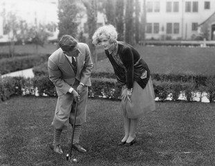 Man talking to woman while golfing 