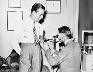 Doctor taking a patients blood pressure 