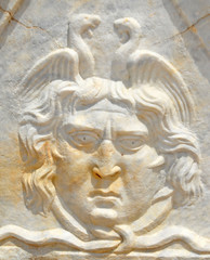 Ancient roman sculpture in marble of a head and birds