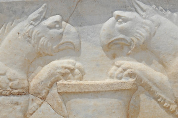 Detail of ancient roman sculpture of two griffons guarding treasure