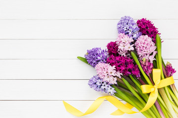 Bouquet of hyacinth flowers on white wooden background. Top view, copy space