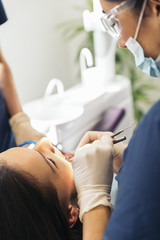 Obraz na płótnie Canvas Dentists with a patient during a dental intervention.