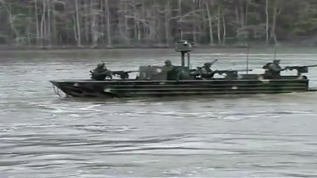 Special ops warcraft practice a river invasion exercise.
