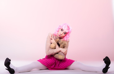 childlike woman with teddy bear toy