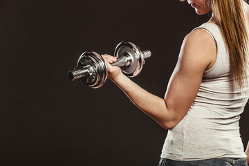 Strong woman lifting dumbbells weights. Fitness.