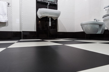 Tilled floor in modern bathroom interior