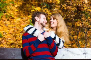 Lovers couple in autumn park on bench