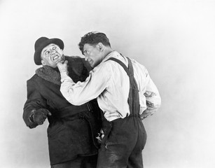 Two men fighting with each other 