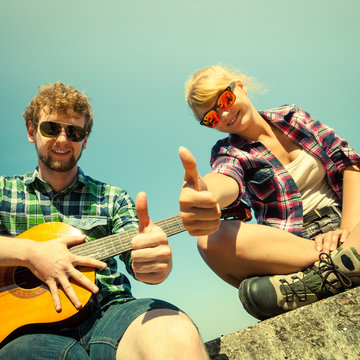 Young man hipster with guitar and woman.